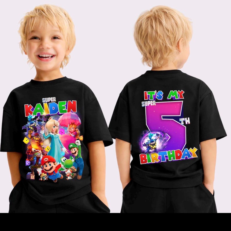 May include: Black t-shirt with a vibrant graphic of video game characters and the name "Kaiden". The back of the shirt says "It's My Super 5th Birthday". The design is in bright colours. The t-shirt is for a child.