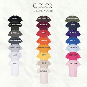 May include: A colour chart of Gildan Youth t-shirts in various colours, including black, white, red, and orange. The text "COLOUR" and "GILDAN YOUTH" are displayed at the top. Each shirt is neatly arranged, showcasing the available colour options.