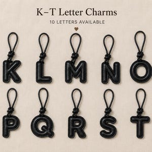 May include: Black letter charms, each with a loop for attachment. The letters K, L, M, N, O, P, Q, R, S, and T are displayed. Text at the top reads "K-T Letter Charms" and "10 LETTERS AVAILABLE".