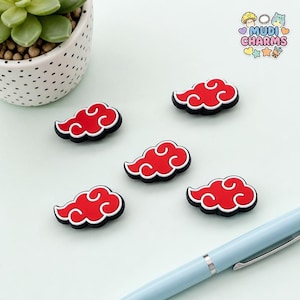 May include: Five red and white cloud-shaped charms with black outlines. The charms feature a stylized swirling design. A logo in the top right corner displays the text MUDI CHARMS with small icons of a mushroom, beads, and a bubble tea cup.
