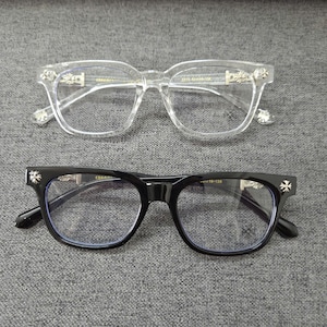 May include: Two pairs of eyeglasses. One pair has a clear frame with silver accents, and the other has a black frame with silver accents. Both pairs have a square shape and are set against a gray background.
