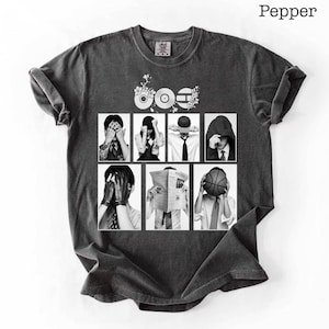 May include: Dark gray t-shirt with a graphic design featuring a collage of black and white images of people covering their faces. The word "Pepper" is printed in the upper right corner.