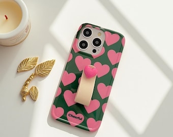 Funda para iPhone con corazones rosas, soporte para correa de anillo y cubierta con agarre 3D.