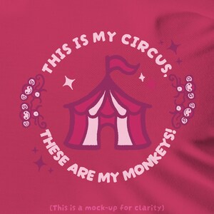 May include: A dark pink t-shirt featuring a graphic of a circus tent in shades of pink and white. The text "THIS IS MY CIRCUS, THESE ARE MY MONKEYS!" is printed in a circle around the tent, accompanied by small monkey faces and star icons.