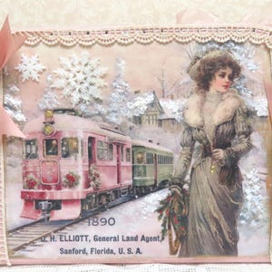 May include: A pink and green train with a woman in a white fur coat and a brown dress standing in front of it. The train is decorated with greenery and the scene is set in a snowy winter landscape. The text on the image reads "1890 D. H. ELLIOTT, General Land Agent, Sanford, Florida, U. S. A."