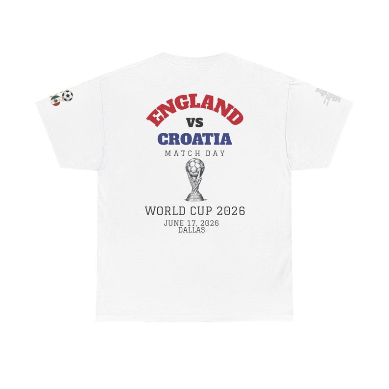 May include: White t-shirt featuring the text "ENGLAND vs CROATIA MATCH DAY" in red and blue. Below, it reads "WORLD CUP 2026 JUNE 17, 2026 DALLAS" with a graphic of the World Cup trophy. Soccer balls are on the left sleeve.