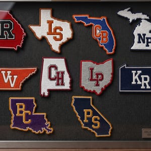 May include: A collection of state-shaped patches, each with a collegiate letter design. The patches are in various colors, including red, orange, blue, and purple, and are displayed in a shadow box. The text "COLLECTOR'S EDITION" is visible.