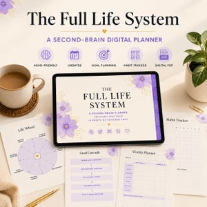 May include: A digital tablet displaying The Full Life System, a second-brain digital planner with purple floral accents. Surrounding the tablet are printed pages including a Life Wheel, Goal Cascade, and Weekly Planner, alongside a coffee mug.
