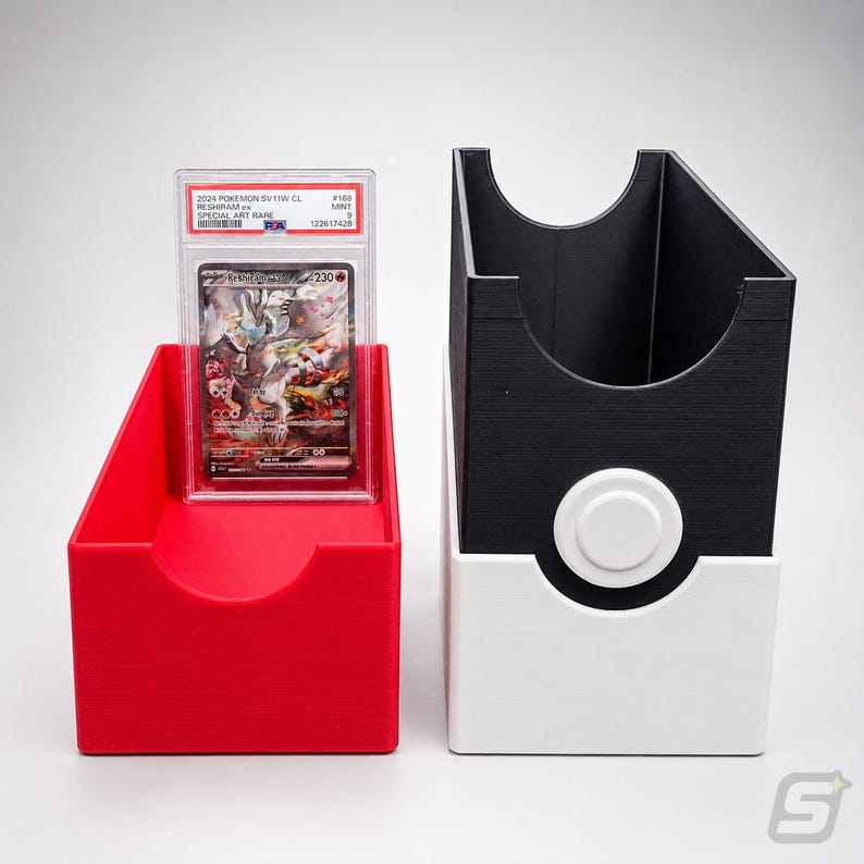 May include: A red plastic card storage box and a black and white plastic card storage box with a circular button design. A PSA graded 2024 Pokemon SV11W CL Reshiram ex Special Art Rare trading card in a clear protective slab sits inside the red box.