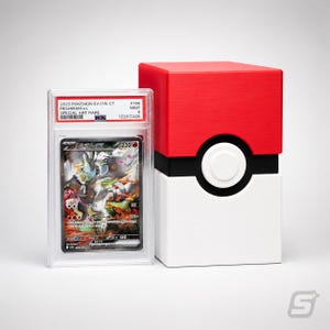May include: A PSA graded 2025 Pokemon SV11W CT Reshiram ex Special Art Rare trading card in a clear plastic slab, positioned next to a red, white, and black storage box designed to resemble a spherical creature-catching device from the game.