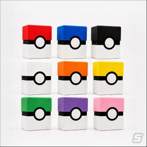 May include: Nine colorful, square-shaped boxes with a white base, black stripe, and a white circle. The tops are red, blue, black, white, orange, yellow, green, purple, and pink. The boxes are arranged in a 3x3 grid.