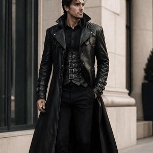 May include: A long black leather trench coat featuring a high collar, metallic studs, and buckled straps on the cuffs. Underneath, a black button-down shirt is paired with a black vest featuring multiple front buckles, black trousers, and black boots.