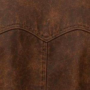 May include: Close-up of a brown leather jacket's back yoke and stitching. The leather has a distressed, textured appearance with variations in colour. The stitching is visible and follows the curved design of the yoke.