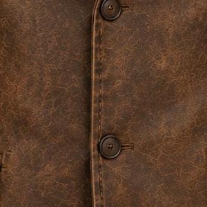 May include: Close-up of a brown leather blazer with two dark brown buttons. The blazer has a textured surface and visible stitching along the seams. The jacket's colour is a rich, warm brown.