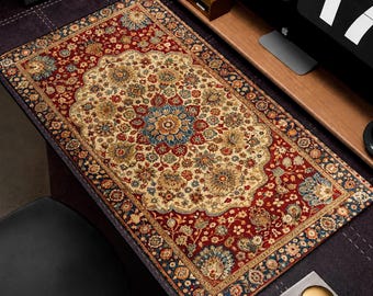 Puede incluir: Alfombrilla de escritorio rectangular con diseño de alfombra persa. La alfombrilla presenta un medallón central de color crema con motivos florales en rojo, azul y dorado, enmarcado por un borde rojo oscuro con motivos florales similares. Mide aproximadamente 79 cm de largo y 41 cm de ancho.