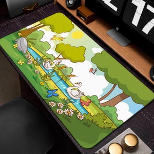 May include: A rectangular desk mat featuring a colourful cartoon illustration of a river scene. Two white swans swim in the blue water, surrounded by green trees, yellow flowers, a grey rock, a yellow sun, and flying butterflies and birds.