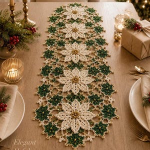 May include: A long, rectangular crochet table runner featuring a repeating pattern of large, cream-coloured poinsettia flowers and smaller, dark green star-shaped motifs. The design is accented with small gold beads throughout the lace-like structure.