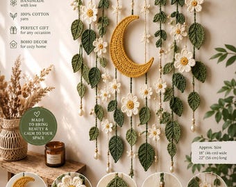 May include: A handmade crochet wall hanging featuring a central yellow crescent moon, white flowers, and green leaves suspended from a wooden branch. The piece includes pearl-like beads and measures 18 inches wide by 22 inches long.