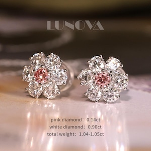 May include: A pair of flower-shaped stud earrings. Each earring features a central pink diamond surrounded by white diamonds, creating a floral design. The total weight is 1.04-1.05ct. The brand name "LUNOVA" is at the top.