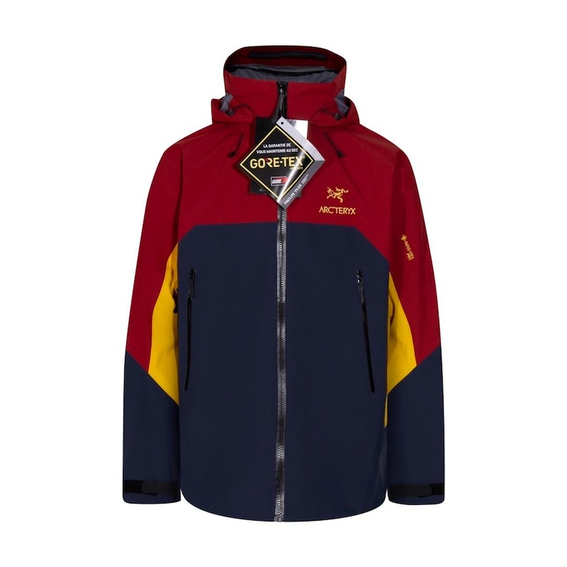 May include: A multi-colored Arc'teryx Gore-Tex jacket. The jacket features a color block design with red, navy blue, and yellow panels. It has a hood, a full-length zipper, and multiple pockets. The Gore-Tex tag is visible.