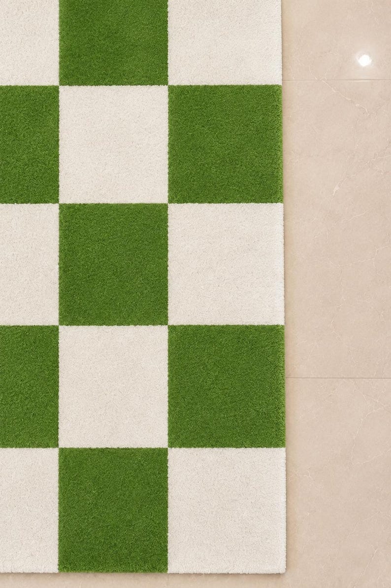 May include: A rectangular area rug featuring a high-pile texture with a repeating checkerboard pattern of alternating grass green and off-white squares. The rug has clean, straight edges and a consistent, dense tufted surface throughout the design.