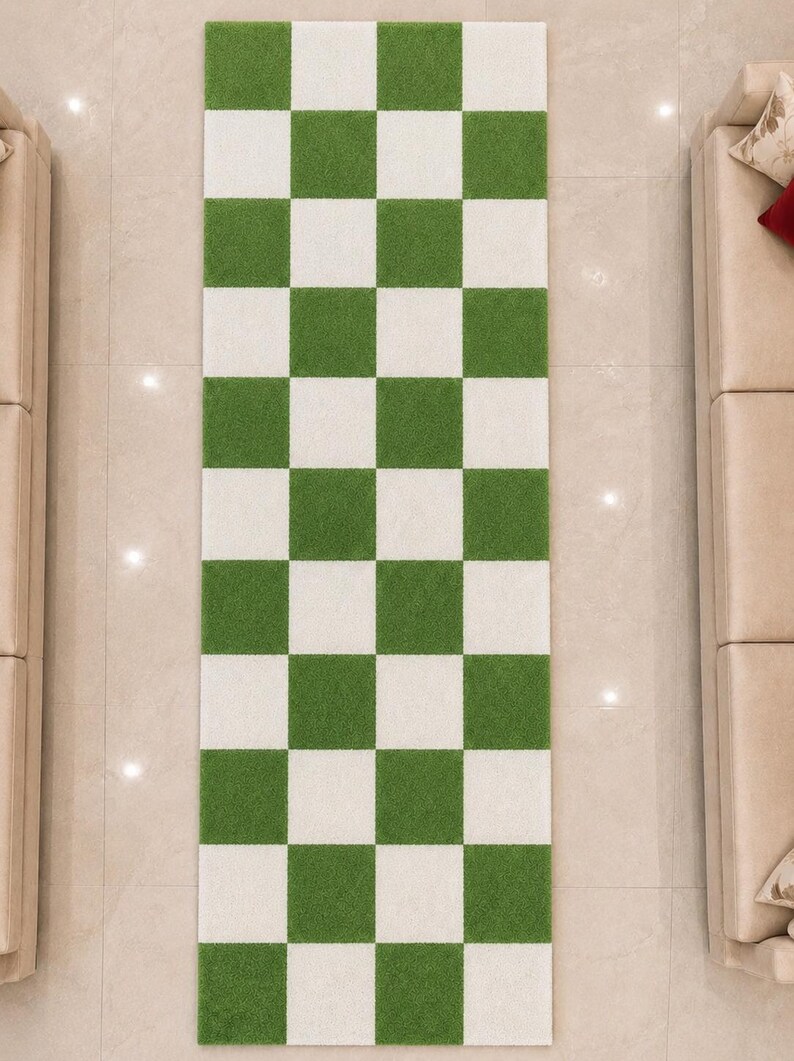 May include: A rectangular runner rug featuring a repeating checkerboard pattern of alternating grass green and white squares. The rug has a textured, pile-like surface and is oriented vertically, displaying a grid of three columns and nine rows.