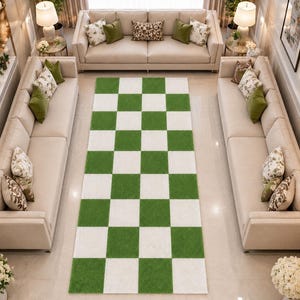 May include: A rectangular area rug featuring a repeating checkerboard pattern of alternating grass green and off-white squares. The rug is positioned centrally on a light-colored floor, displaying a clean, geometric design with a uniform grid layout.