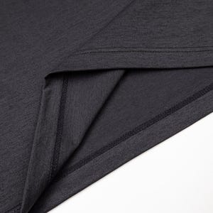 May include: Close-up of a dark gray t-shirt, showcasing the neckline and hem. The fabric has a subtle texture, and the seams are neatly stitched. The image highlights the garment's construction and material.