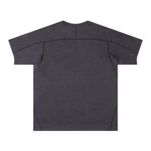 May include: Dark gray t-shirt with a crew neck and short sleeves. The shirt features visible stitching details along the shoulders, sleeves, and back. The fabric has a textured appearance.