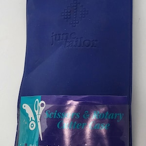 May include: Blue fabric case with a clear plastic window showing a pair of scissors and the text "Scissors & Rotary Cutter Case". The case has the text "june tailor" and "RICHFIELD, WISCONSIN" printed on it.