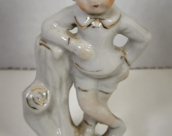 Boy leaning on tree stump figurine Made in Japan