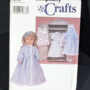 May include: Simplicity Crafts sewing pattern number 7449 for a doll's nightgown. The pattern includes instructions for making a white slip, a white nightgown, and a blue and white gingham nightgown. The pattern is for one size.