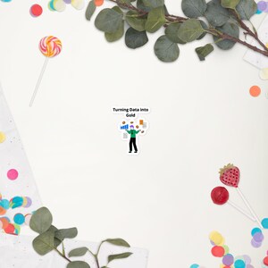May include: A white sticker featuring the text "Turning Data into Gold" and a graphic of a person juggling data charts and coins. The sticker is surrounded by colourful confetti, a lollipop, and greenery.