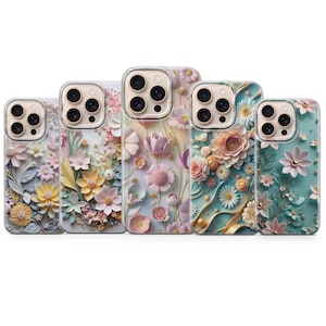 May include: Five phone cases with floral designs. The cases feature a variety of pastel colors, including pink, yellow, and blue. Each case has a different arrangement of flowers, with some featuring 3D elements.