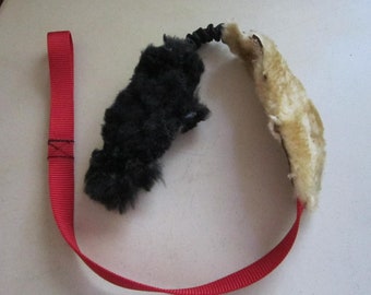 Webbing with 2 pieces of genuine sheepskin with bungee cord between for tug and play