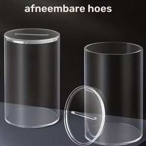 K&ouml;nnte beinhalten: Transparenter zylindrischer Beh&auml;lter aus Acryl mit einem Schlitz im Deckel. Der Deckel ist abnehmbar und der Beh&auml;lter ist transparent, wodurch der Inhalt sichtbar ist. Der Text "afneembare hoes" steht oben.