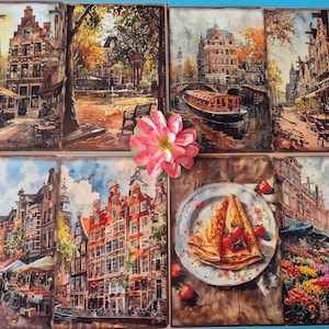 Może przedstawiać: Zestaw sześciu kwadratowych wydruk&oacute;w artystycznych przedstawiających sceny z Amsterdamu w Holandii. Wydruki przedstawiają kanały, budynki, kawiarnie i ł&oacute;dź. Widoczny jest r&oacute;wnież r&oacute;żowy kwiat i talerz naleśnik&oacute;w z truskawkami.