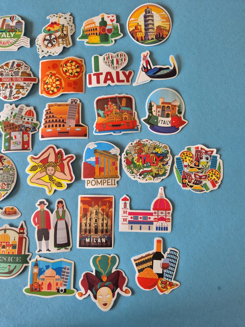 May include: A collection of colorful Italy-themed stickers featuring iconic landmarks, food, and cultural symbols. Designs include the Leaning Tower of Pisa, pizza, gondolas, and the Colosseum. The stickers are on a light blue background.