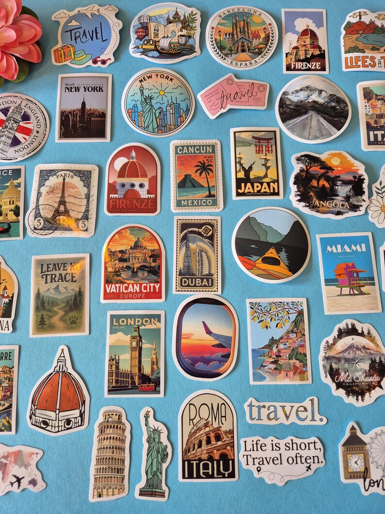 May include: A collection of travel-themed stickers featuring iconic landmarks and destinations. Stickers include the Eiffel Tower, Statue of Liberty, Big Ben, and the Colosseum. The stickers are in various shapes and sizes, with vibrant colors and text.