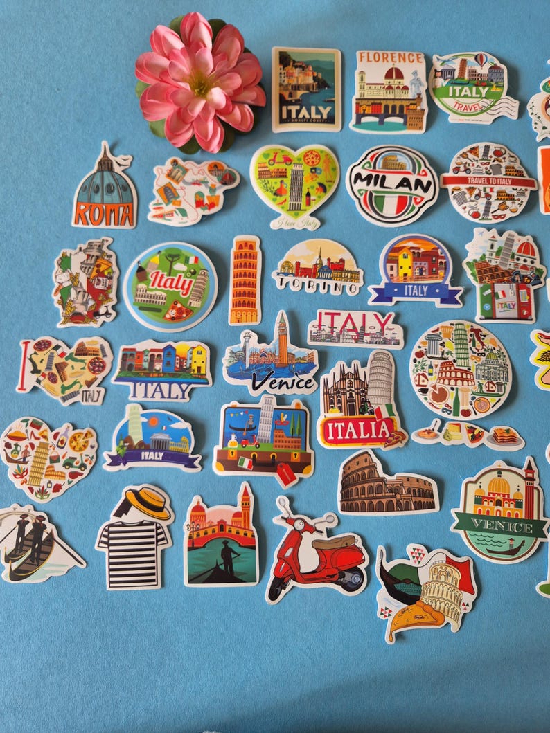 May include: A collection of colorful Italy-themed stickers featuring landmarks like the Leaning Tower of Pisa, the Colosseum, and gondolas. Some stickers have text like "Italy", "Rome", "Venice", and "Florence". A pink flower is also present.