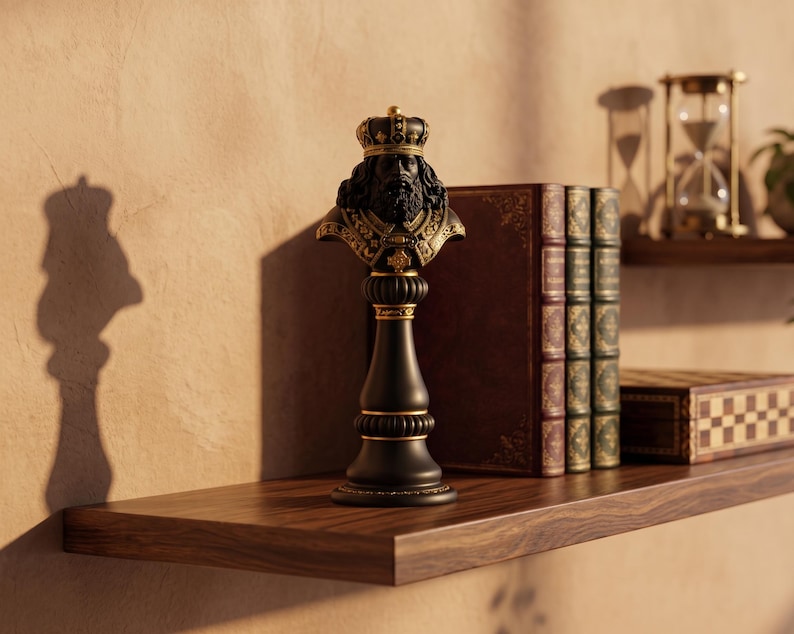 May include: A black and gold chess piece depicting a king's bust with a crown. The chess piece is on a wooden shelf with books, a chessboard, and an hourglass. The bust has a detailed beard and crown.