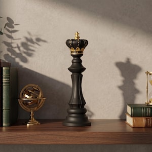 May include: A black chess piece in the shape of a king with a gold crown sits on a wooden shelf. Beside it are books, a golden armillary sphere, and an hourglass. The scene is lit with natural light, casting shadows.