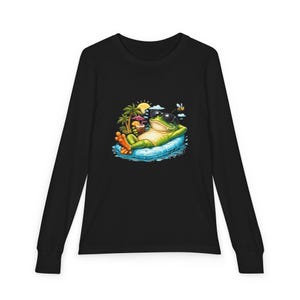 May include: Black long-sleeve shirt featuring a cartoon frog wearing sunglasses and relaxing on a pool float. The frog is holding a tropical drink, with a beach scene in the background.