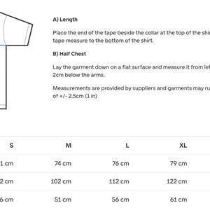 May include: Diagram illustrating how to measure a t-shirt for length and width. Includes measurements in centimeters and inches for sizes S through 3XL. The diagram shows where to measure the length and half chest.