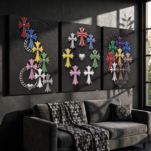 May include: A triptych of black canvas wall art featuring embossed Chrome Hearts logos and various colourful cross motifs. The left panel shows crosses linked by silver chains, the centre panel displays a circular arrangement, and the right panel features a cluster of crosses.