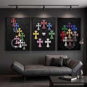 May include: Three framed wall art prints featuring black backgrounds with embossed circular motifs and the text CHROME HEARTS. The artwork displays various colourful cross-shaped emblems in red, blue, yellow, green, pink, white, and metallic tones.