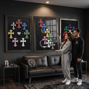 May include: Three framed wall art pieces featuring multi-coloured cross emblems arranged in circular and cascading patterns. The artwork displays red, blue, yellow, green, pink, white, and silver crosses against a dark background with metallic chain accents.