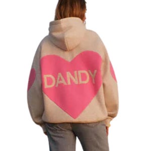 May include: Beige hoodie with a large pink heart graphic on the back. The word "DANDY" is printed in white within the heart. A smaller pink heart is on the left sleeve. The hoodie has a hood and long sleeves.