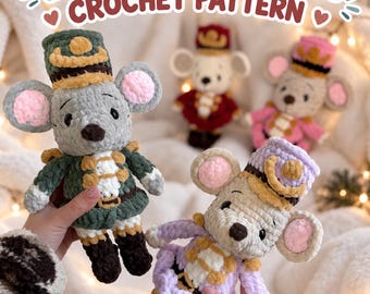 May include: Crochet pattern titled Ella & Emil, the Mice featuring four plush mouse dolls dressed as nutcracker soldiers in various colors including dark green, red, pink, and light purple with matching hats and detailed uniforms.