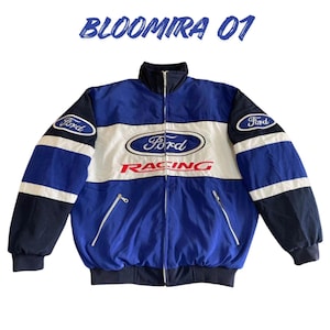 May include: Blue, white, and black racing jacket with the Ford logo prominently displayed on the chest and sleeves. The jacket features a full zipper, a stand-up collar, and the text "BLOOMIRA 01" at the top.